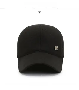 Detail view of black baseball cap with metallic R logo and fleece lined fabric for winter
