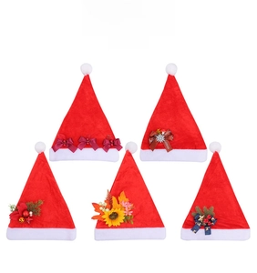 Detail view of five assorted plush red Christmas hats with various festive decorative bows
