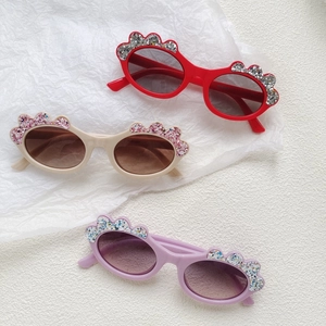 Kids oval glitter sunglasses in candy colors with cloud flower decor on white background