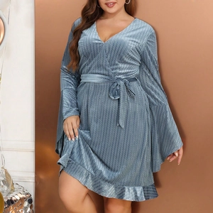 Detailed view of the zigzag texture fabric and V-neckline of the dark blue dress