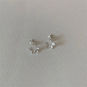 Macro detail of 925 sterling silver flower earrings with butterfly backings