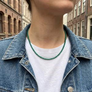 Handmade emerald green beaded necklace with gold spacer beads worn with casual outfit