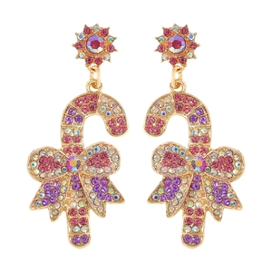 Detail of Christmas candy cane earrings with pink rhinestones and a gold bow pendant