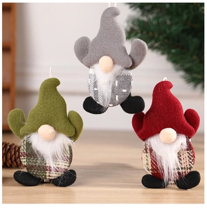 Detailed view of three felt Christmas gnomes in grey, green, and red on a wooden table