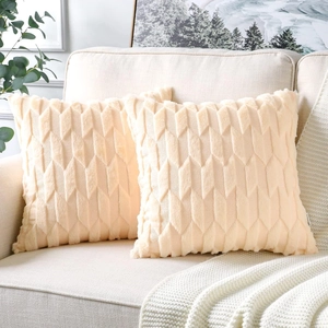 Detail of beige plush pillow covers with 3D diamond texture on a cozy modern sofa