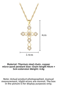 Detailed view of gold cross pendant with cubic zirconia inlay and 4cm x 2.4cm dimensions