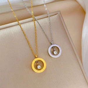 Roman numeral circle necklaces in gold and silver steel finishes on a silk display tray