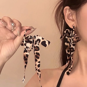 Stylish leopard print bow earrings with long streamers and tassels for a bold look