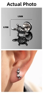 Macro detail of vintage silver turtle stud and mermaid earring on human ear
