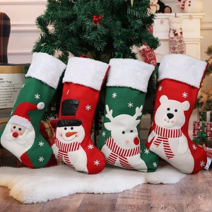 Set of four Christmas stockings with Santa, snowman, and reindeer on faux fur rug