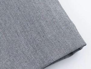 Detailed close-up showing the grey twill crepe fabric texture and fine stitching detail