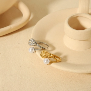 Elegant 18K gold and silver lava open rings with pearls and zircon on ceramic decor