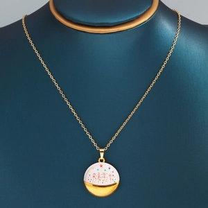 Close-up of gold chain necklace with enamel circle pendant on jewelry mannequin