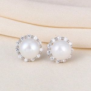 Elegant S925 silver stud earrings featuring round white pearls and sparkling zircon halo