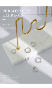 Close-up of S925 sterling silver hoop earrings with textured beaded edge detail