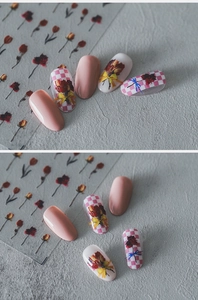 Detail of floral nail stickers featuring tulips and bows on glossy pink manicure tips