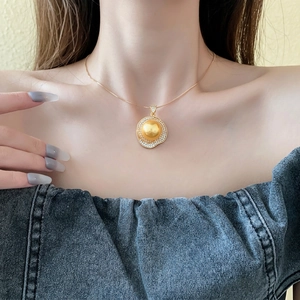 Vintage irregular golden zircon pearl necklace on a model wearing dark denim outfit