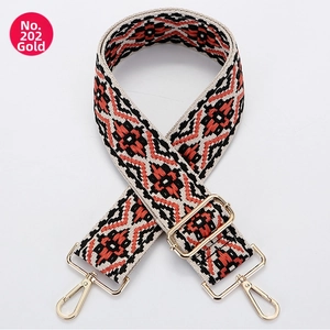 Macro detail of geometric ethnic pattern canvas strap with adjustable gold hardware