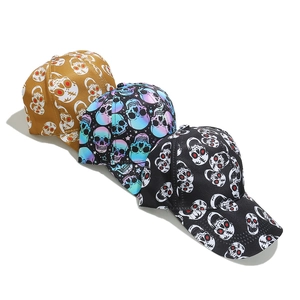 Three punk style skull print baseball hats in tan, purple gradient, and black colors