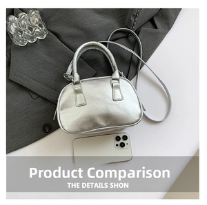Top view of metallic silver bowling bag with textured finish beside a mobile phone