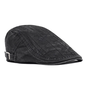 Detail of grey washed cotton flat cap featuring wavy stitching and metal side buckle