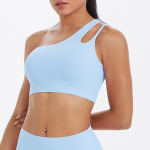 Detail showing the light blue one-shoulder yoga bra with asymmetrical hollow-out strap