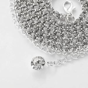 Close-up of sparkling rhinestone waist chain with detailed drop pendant and silver links