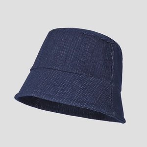 Detailed view of dark blue denim bucket hat showing vertical fine texture and stitching