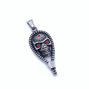 Gothic silver skull pendant with red stone eyes appearing from a zipper opening design