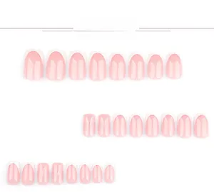 Detail of French press-on nails with white tips, 3D bows and rhinestone accents