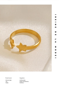 Detail of 18K gold-plated adjustable star ring on silk background with branding