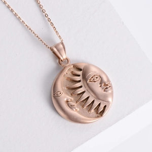 Vintage rose gold stainless steel sun and moon face pendant necklace on white stone