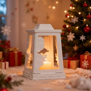 White Christmas lantern candle holder with hollow Santa Claus carvings and warm candle light