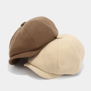 Classic newsboy caps in dark brown and beige with textured herringbone fabric