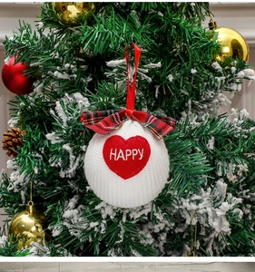 Christmas tree hanging ornament with red bow and embroidered heart on branch