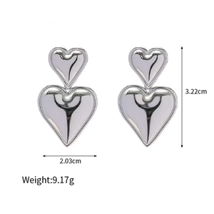 Polished silver heart stud earrings with size and weight measurements on white background