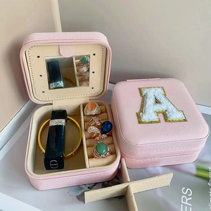 Pink portable jewelry box with mirror and letter A detail for rings and necklaces