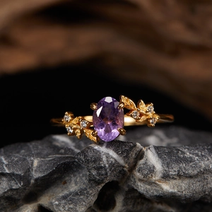 S925 silver 18K gold ring with oval natural amethyst and leaf accents on dark rock