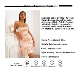 Detail of champagne satin strapless dress showing ruffled hem and smooth ruched fabric texture