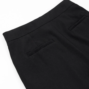 Close-up of black suit pants waist structure and rear welt pocket details