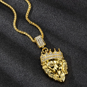 Hip hop gold lion head necklace with crown and sparkling crystals on black background