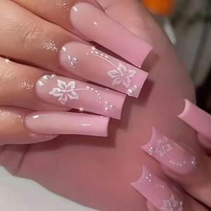 Pink gradient long square press-on nails with white flower patterns and pearl accents