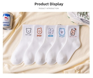 Close-up of five pairs of white cotton socks with cute bear and rabbit animal embroidery