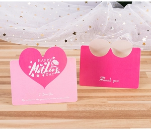 Detail of pink Mother's Day heart card and magenta Thank You card on a wooden surface