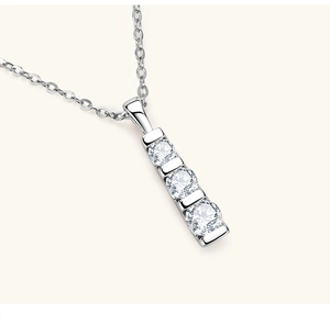 Macro view of a 925 sterling silver necklace featuring a vertical three-stone pendant