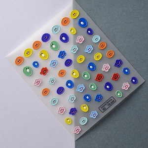 Macro shot of 5D embossed nail stickers featuring colorful smiley faces and clouds TS-244