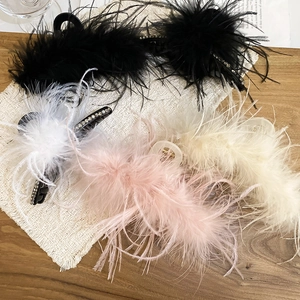 Close-up of feather hair claws in four colors featuring sparkling rhinestone edges