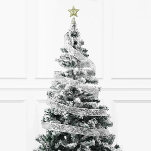 Close-up of semi-transparent silver Christmas ribbon with snowflake patterns on a tree