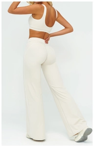 Detail view of high-waist wide-leg yoga pants and u-back sports bra set in cream white