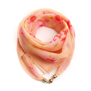 Detail view of pink and orange floral chiffon scarf with golden magnetic clasp closure